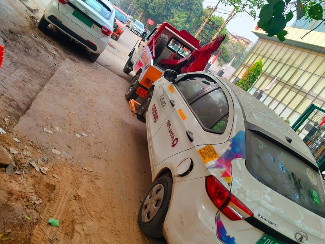 Car being recovered by towing service vehicle